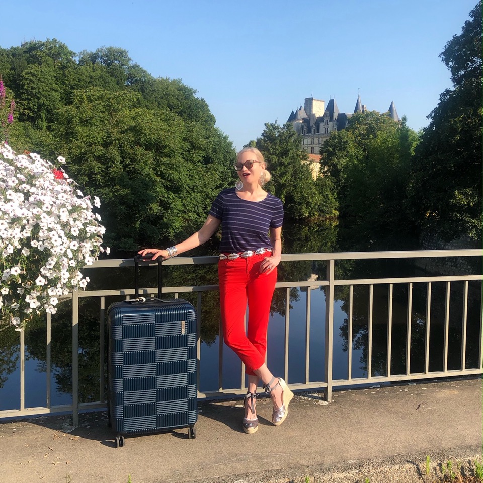 Lifestyle Blogger, Jamie Lewinger of More Than Turquoise, with checkered harassed luggage from American Tourister