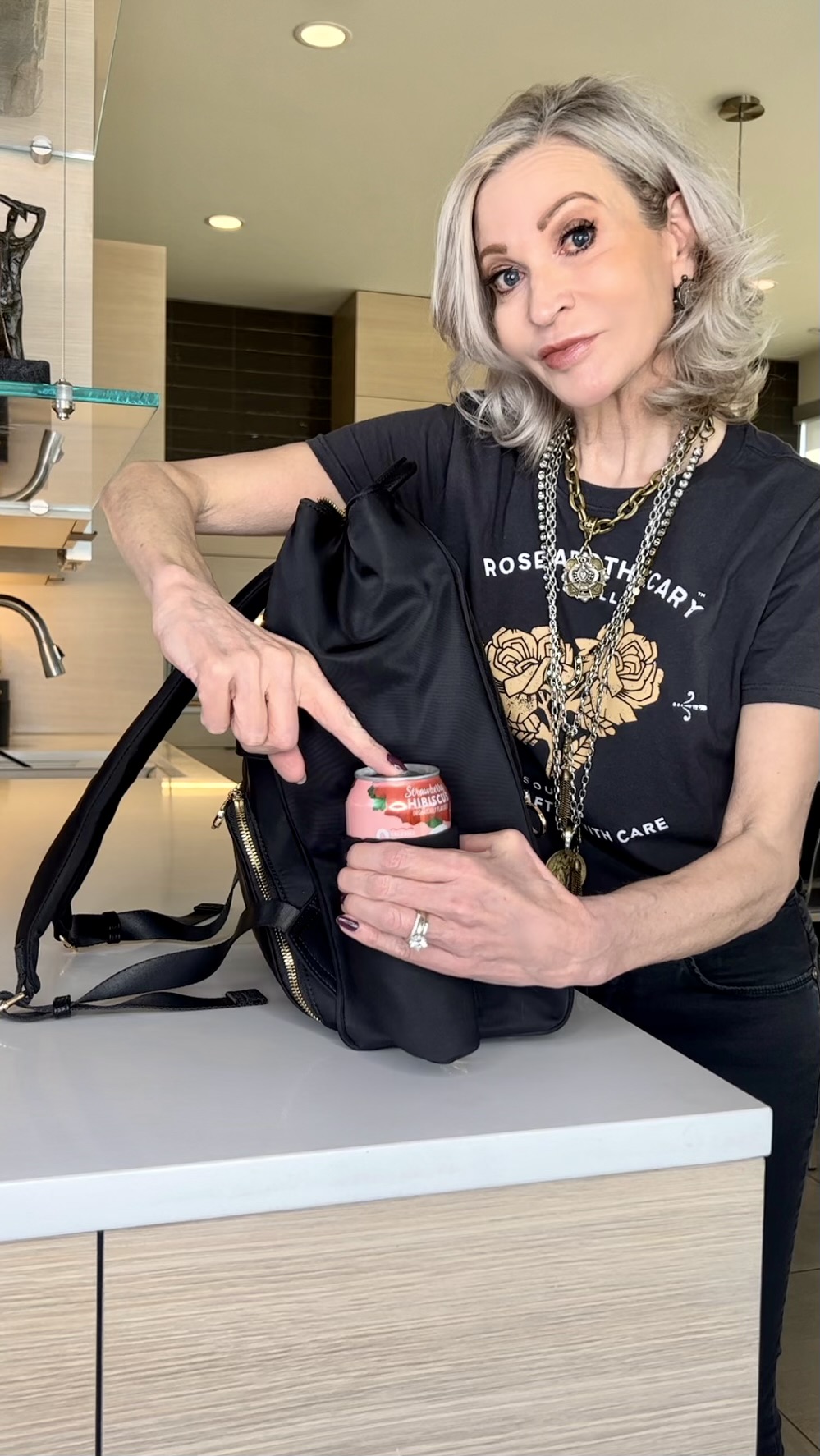 Lifestyle Influencer, Jamie Lewinger of More Than Turquoise showing beverage pocket on MinkeeBlue Amber backpack 