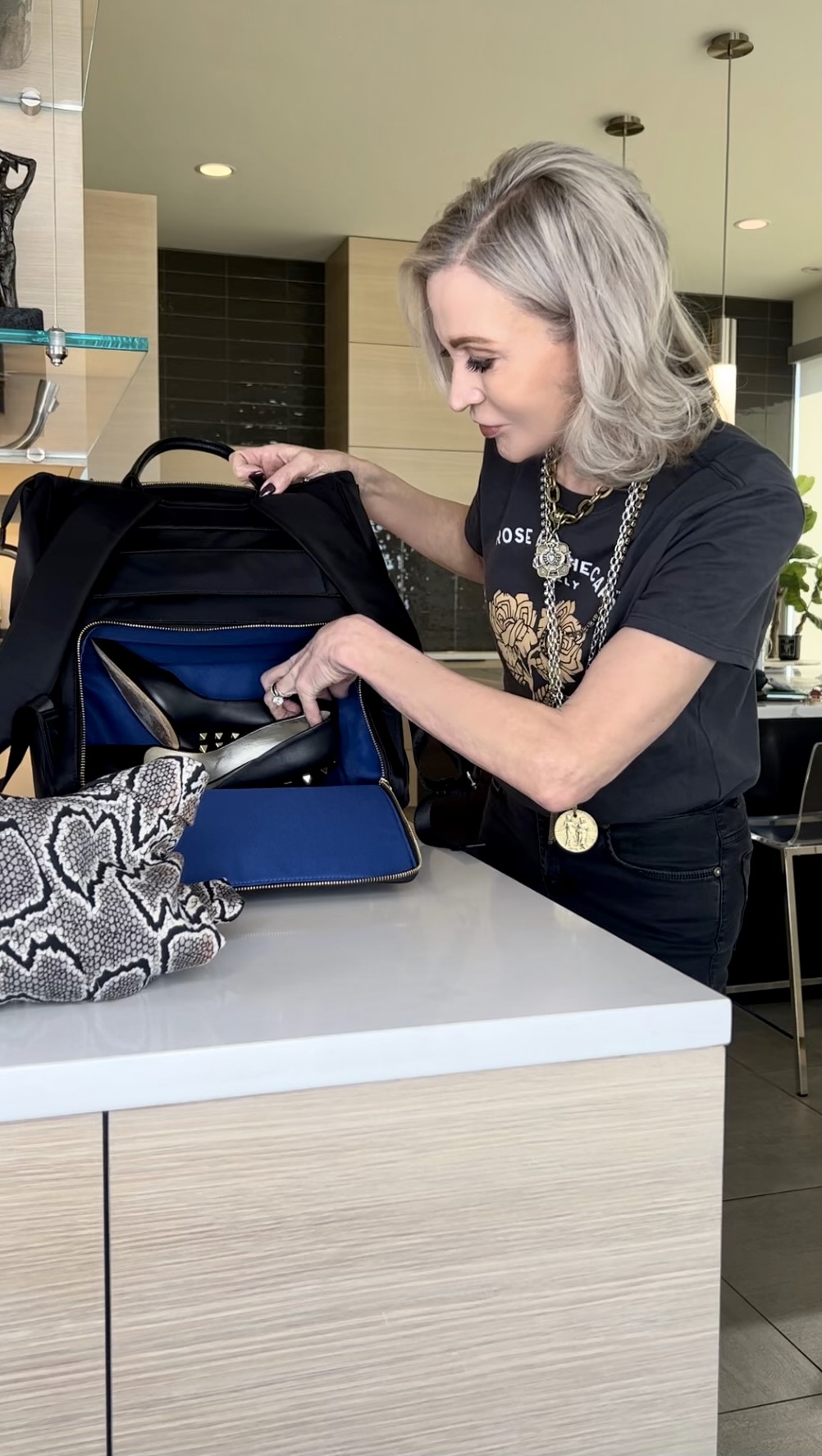Lifestyle Influencer, Jamie Lewinger of More Than Turquoise showing larger compartment on  the MinkeeBlue  Amber backpack