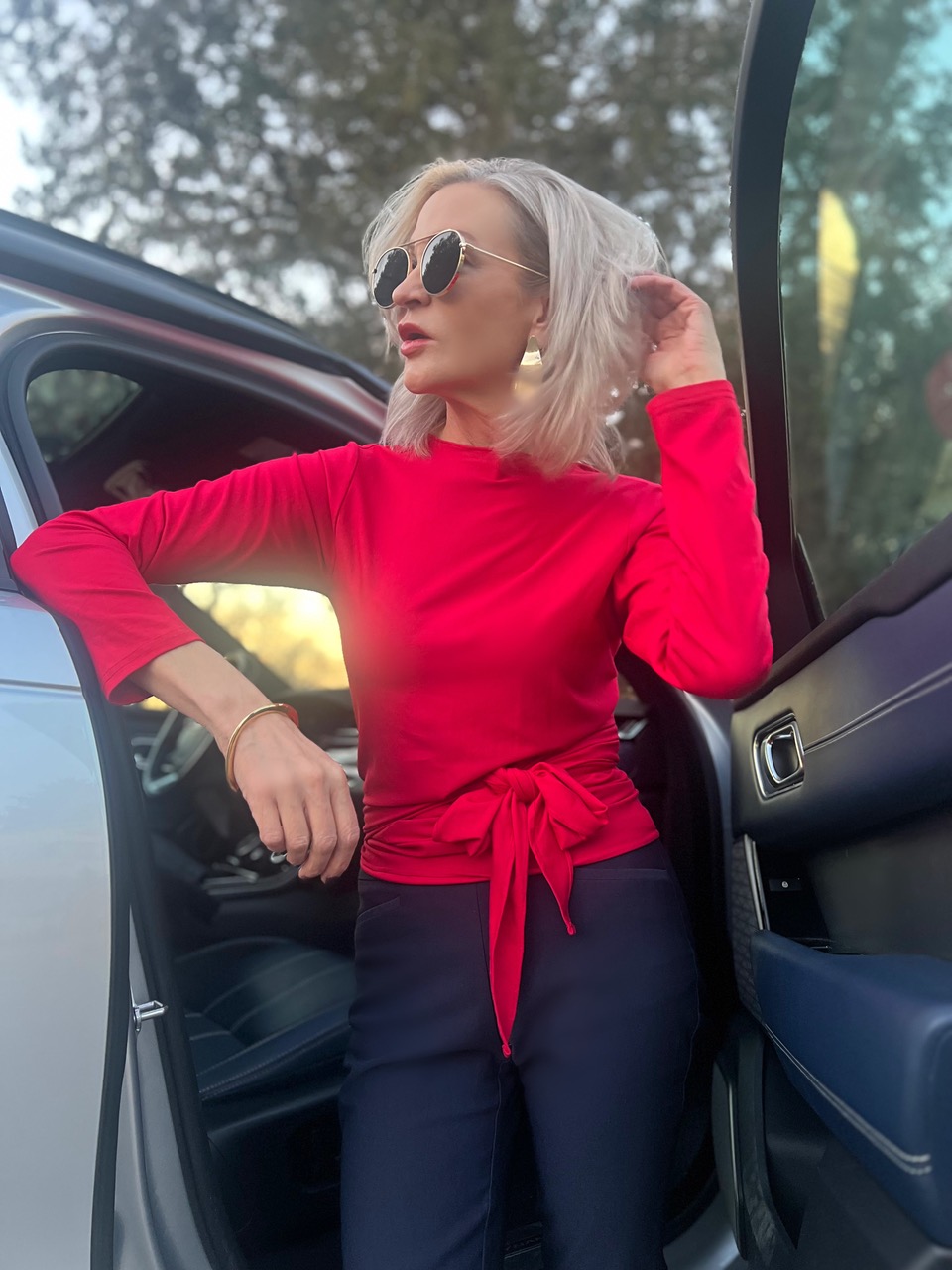Lifestyle Influencer, Jamie Lewinger of More Than Turquoise wearing Diane Kroe wrap top in red  & Pamela Lauz Synergy cuff in gold