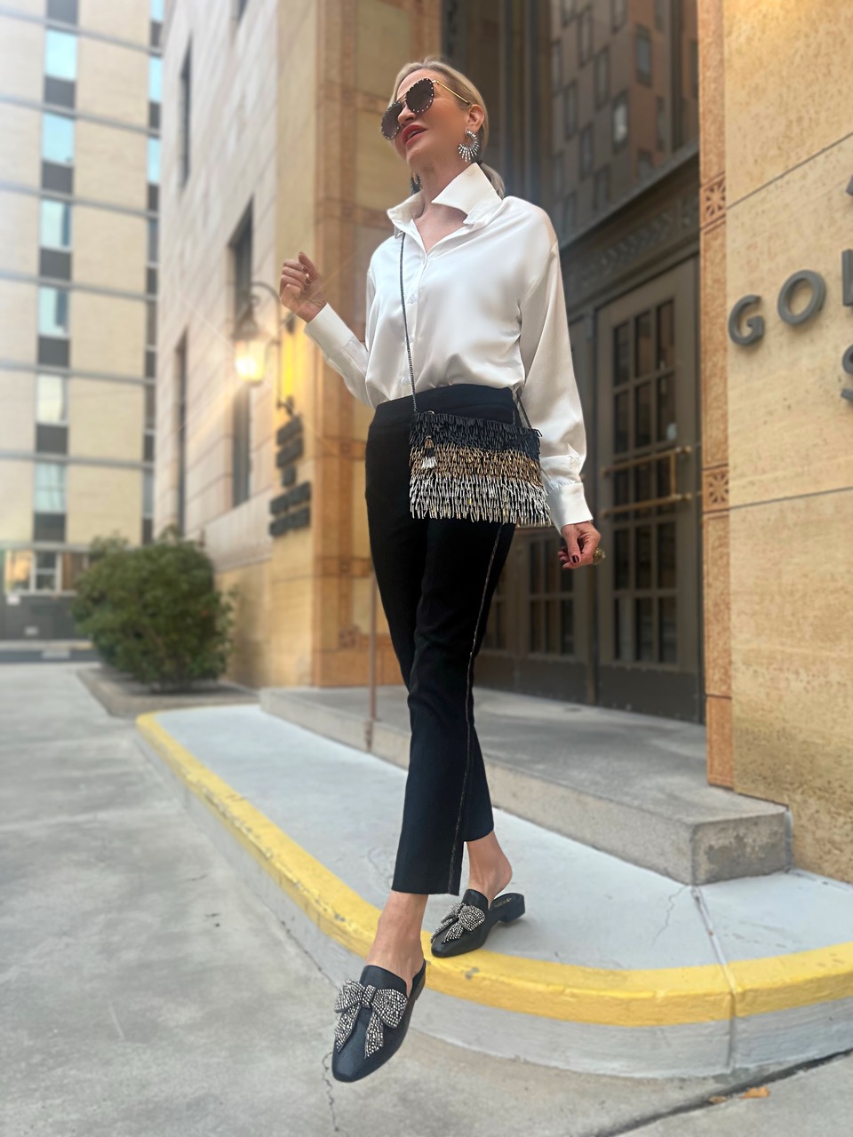 Lifestyle Influencer, Jamie Lewinger of More Than Turquoise wearing embellished bow leather mules from chicos in black
