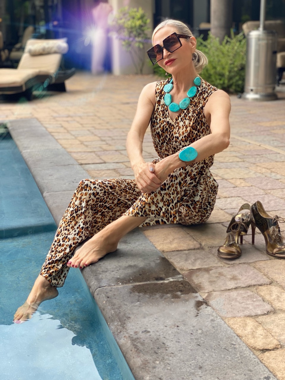 Lifestyle Influencer, Jamie Lewinger of More Than Turquoise wearing chico's jaguar print jumpsuit