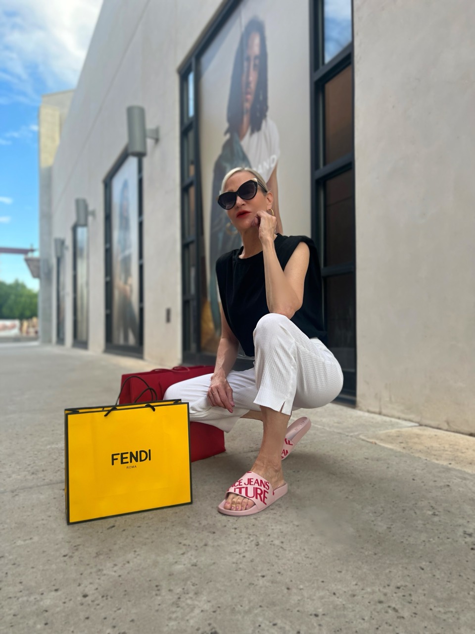 Lifestyle influencer, Jamie Lewinger of More Than Turquoise wearing  Versace sandals from Italist 