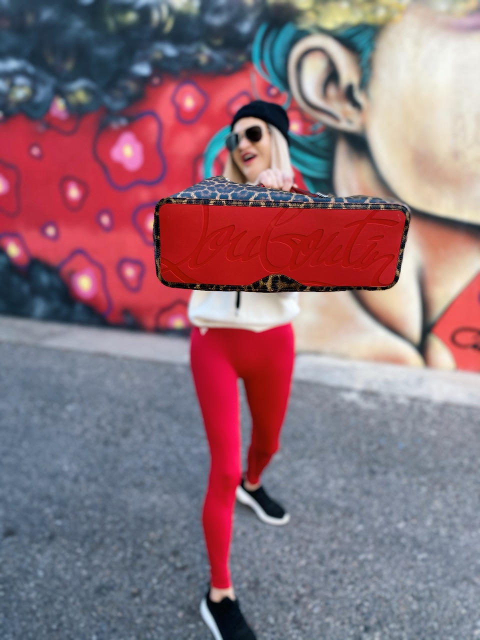 Lifestyle Influencer, Jamie Lewinger of More Than Turquoise, carrying Christian Louboutin animal print tote